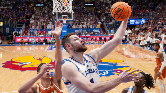 Feb 24, 2024; Lawrence, Kansas, USA; Kansas Jayhawks center Hunter Dickinson (1) shoots under the basket as Texas Longhorns forward Kadin Shedrick (5) defends during the second half at Allen Fieldhouse. Mandatory Credit: Denny Medley-USA TODAY Sports  